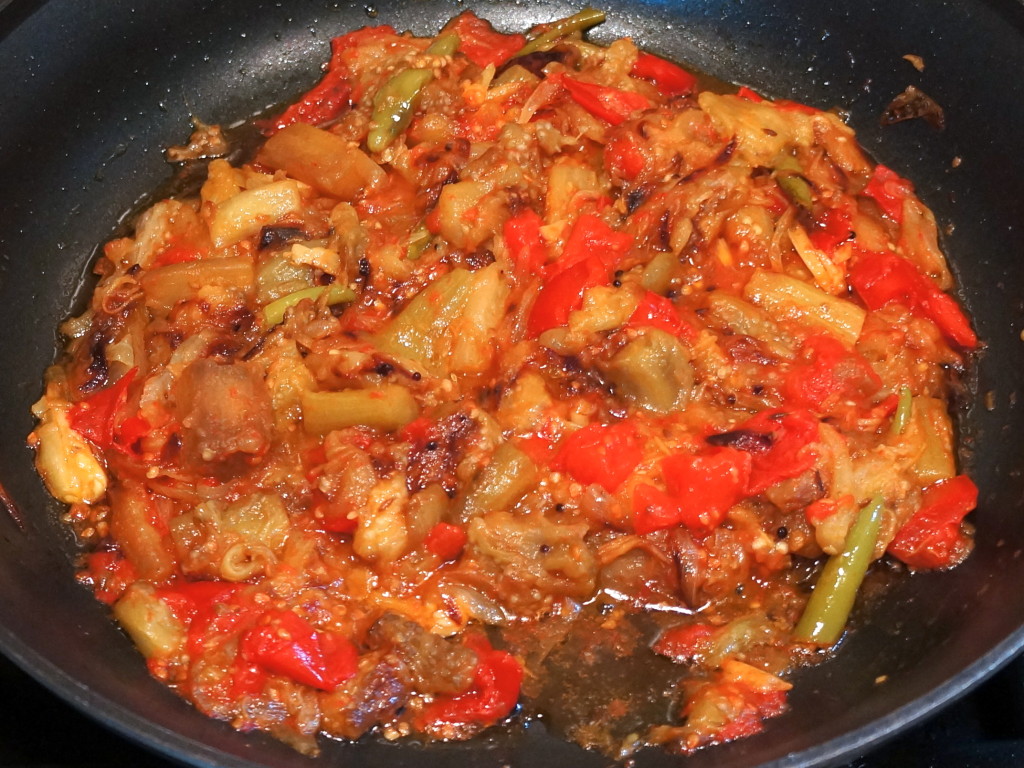 Baigan and tomato cooking--it should be very soft and easily mashed with the back of a wooden spoon